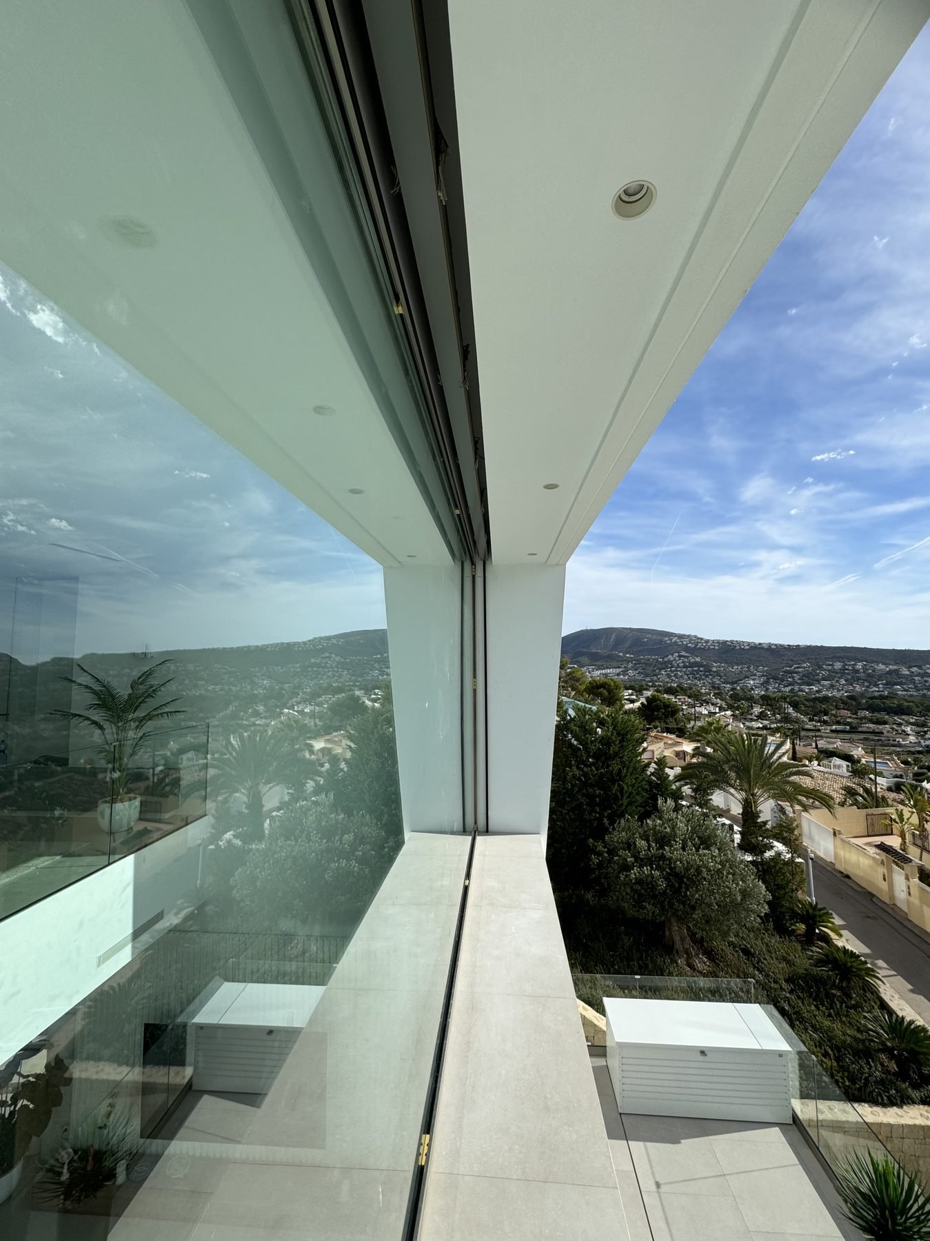 Balcón con barandilla de cristal y vistas panorámicas sobre Moraira recién pintado