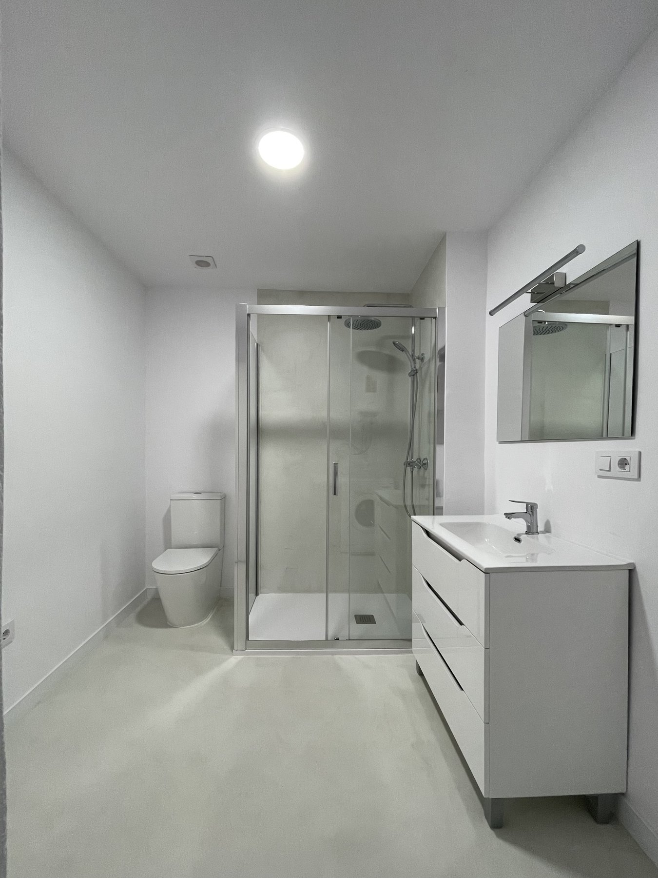 Baño reformado con microcemento claro en Pedreguer